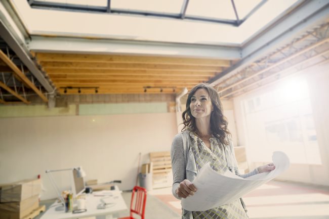 woman looking at building plans